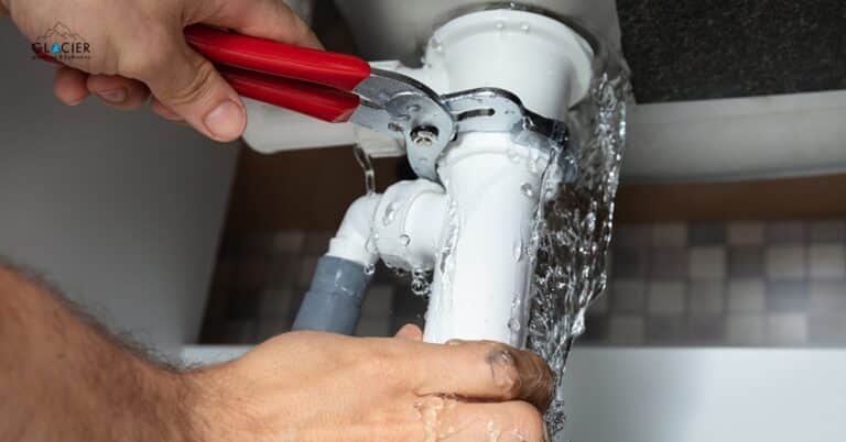 Emergency plumber inspecting burst pipe in Utah home