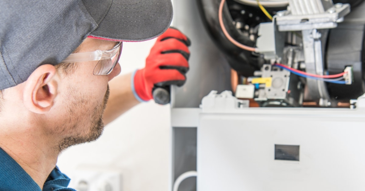 Professional plumber performing boiler maintenance in Salt Lake City home