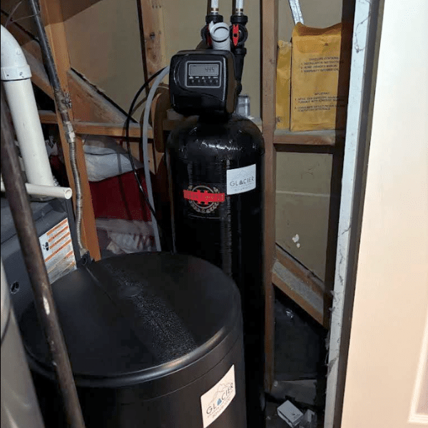 Technician using tools to repair water softener connections